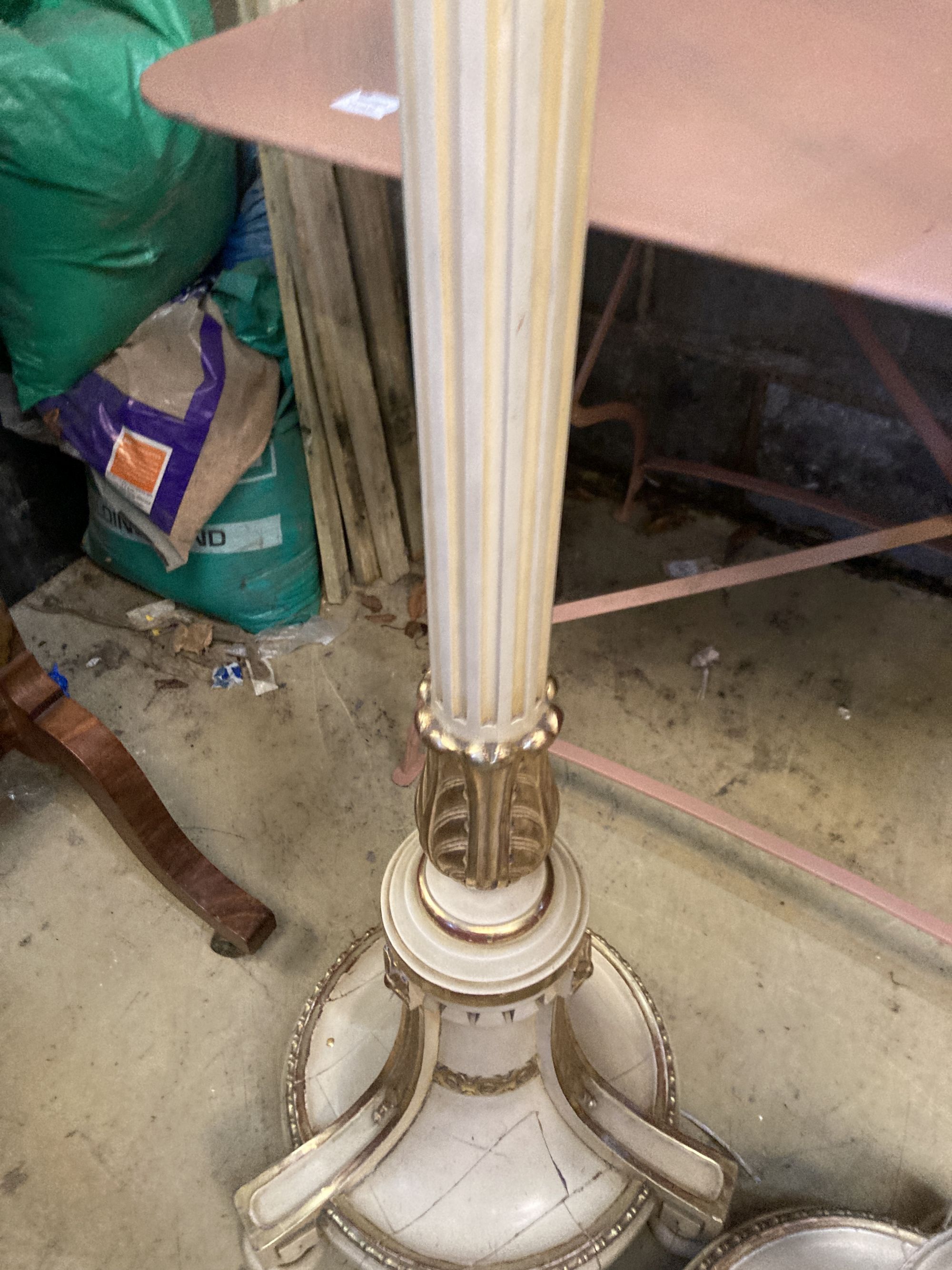 A pair of cream painted parcel gilt standard lamps, height 166cm